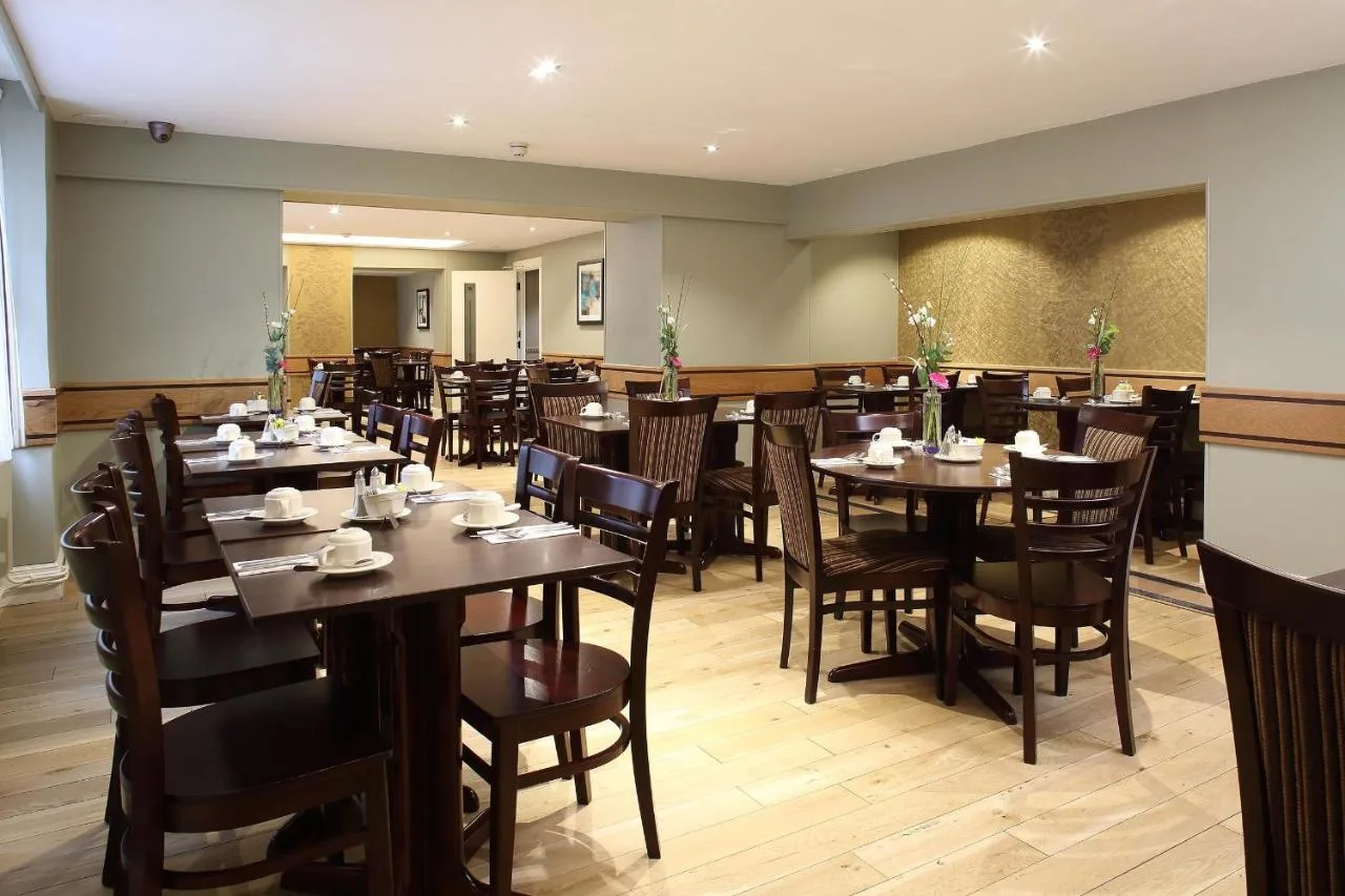 a dining room filled with tables and chairs at Phoenix Hotel in London
