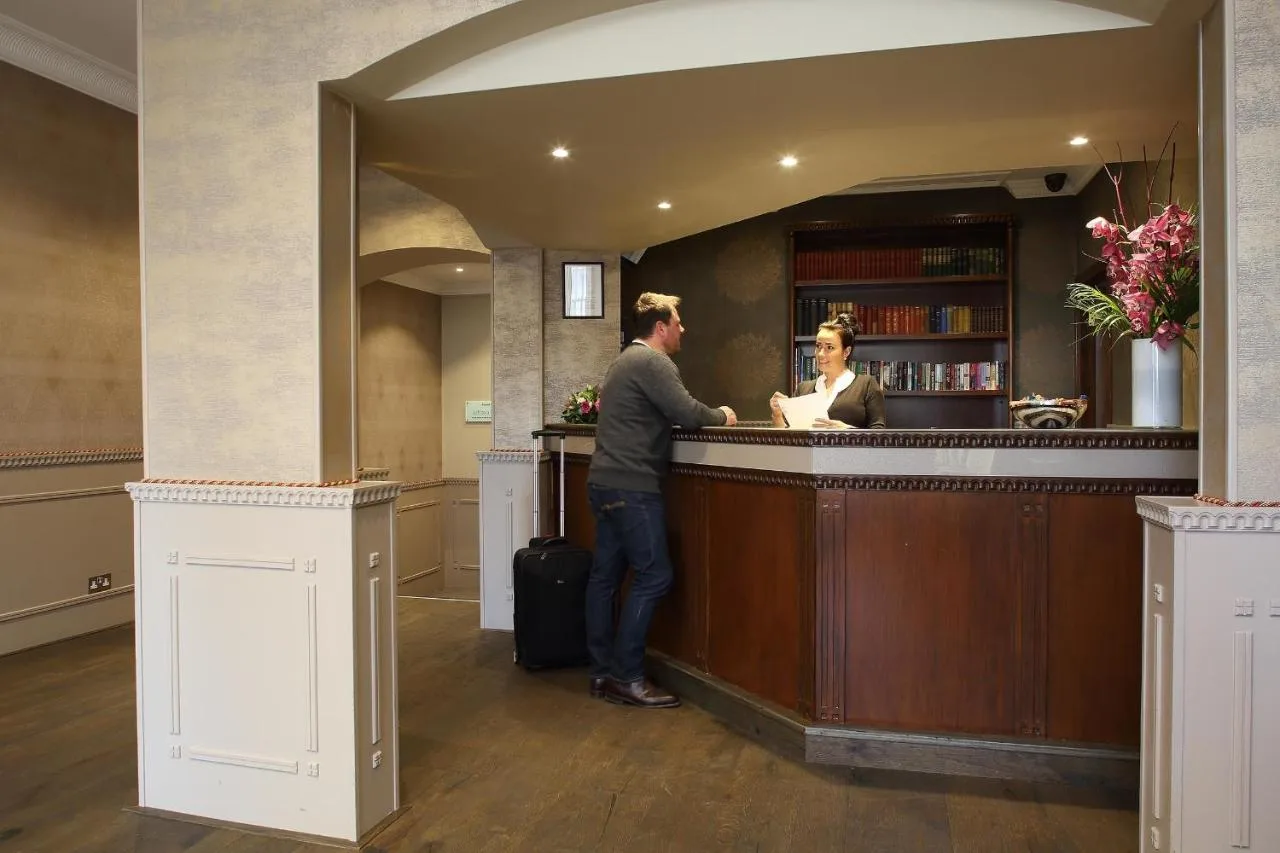a man and a woman standing at a bar at Phoenix Hotel in London