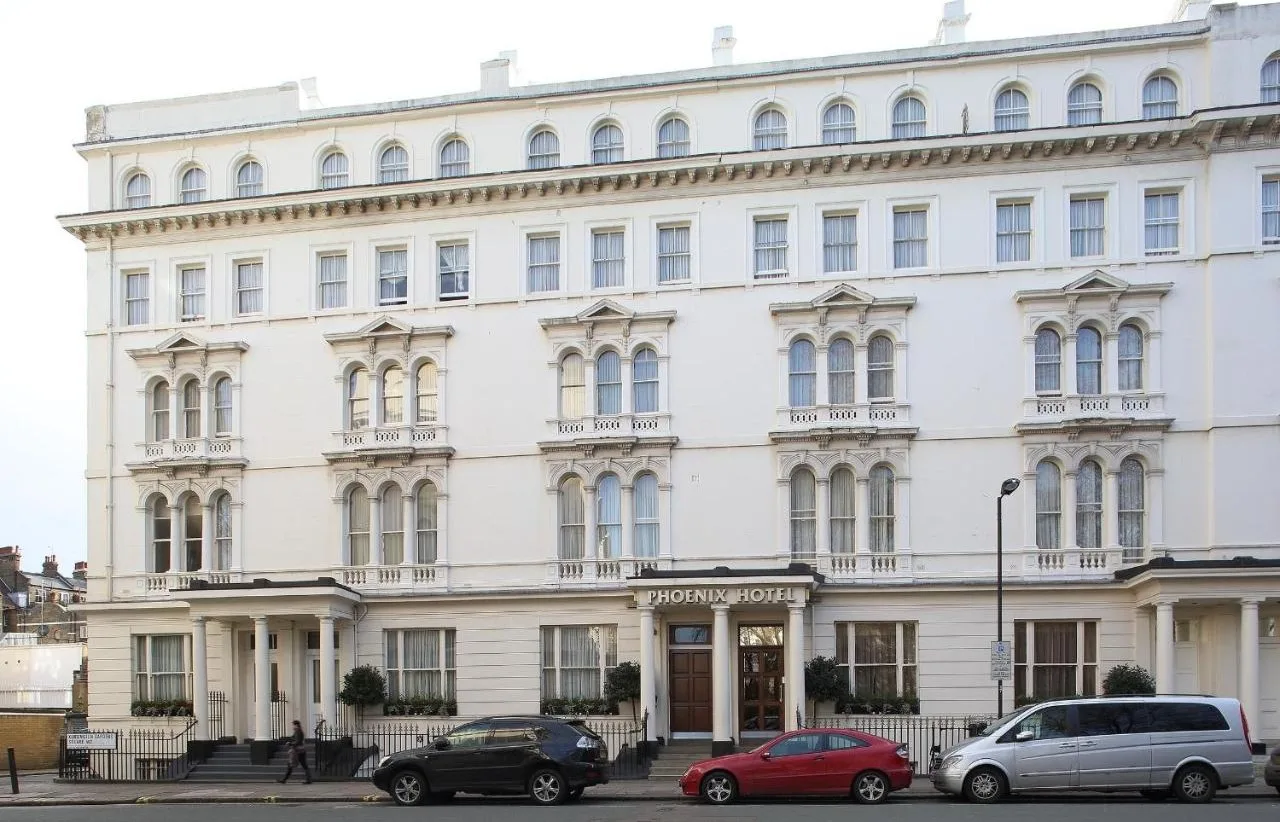 a large white building with cars parked in front of it at Phoenix Hotel in London
